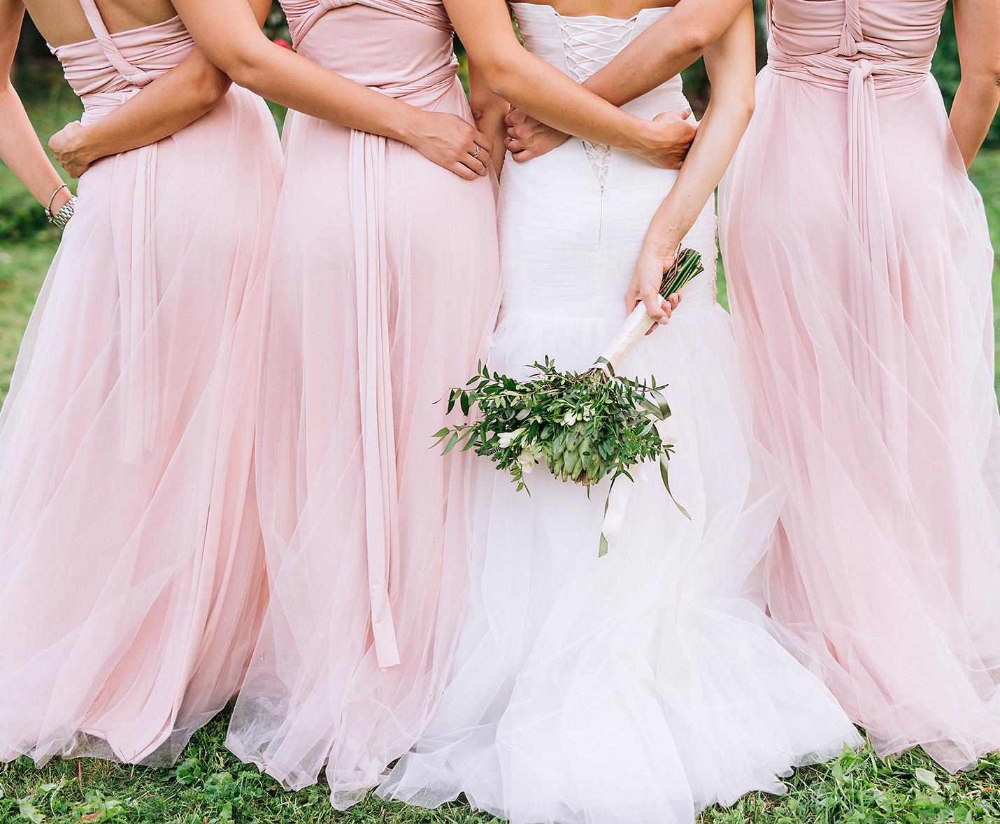 A bride and her bridesmaid with their backs to the camers